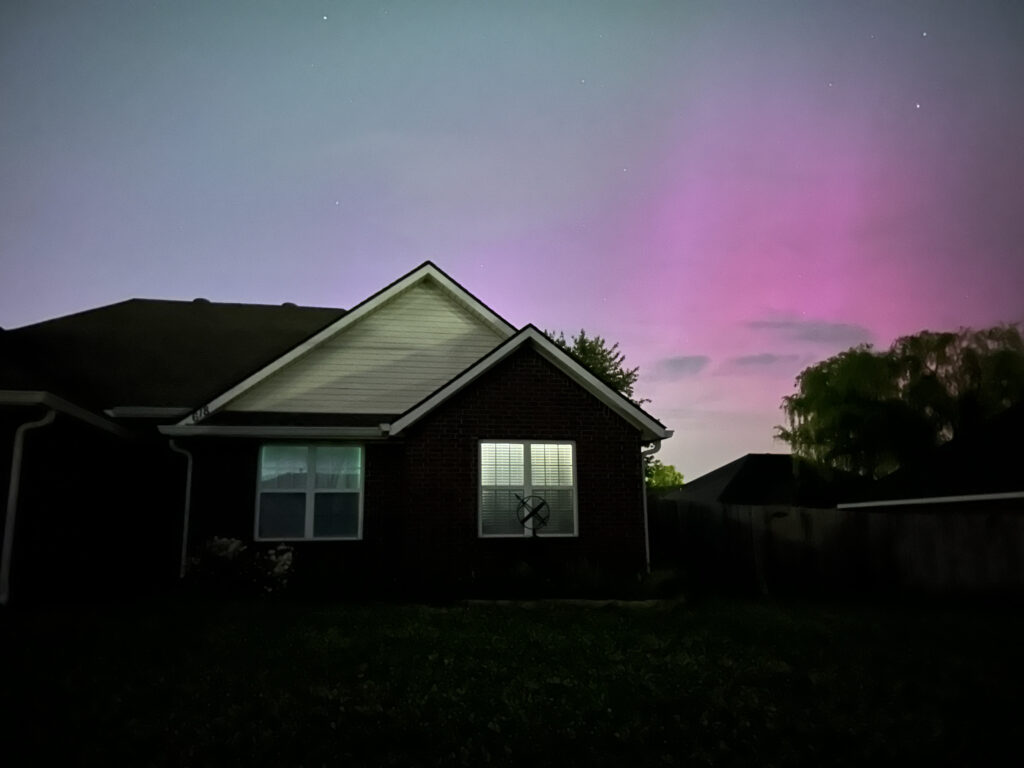 Brick house with long exposure pink, purple and teal in the sky above