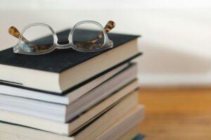 Stack of books with clear glasses on top