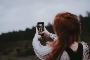 Long haired ginger woman takes selfie