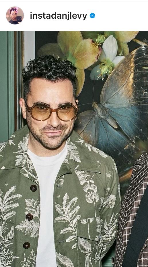 Dan Levy on Instagram with an olive green coat and white leaves printed on it