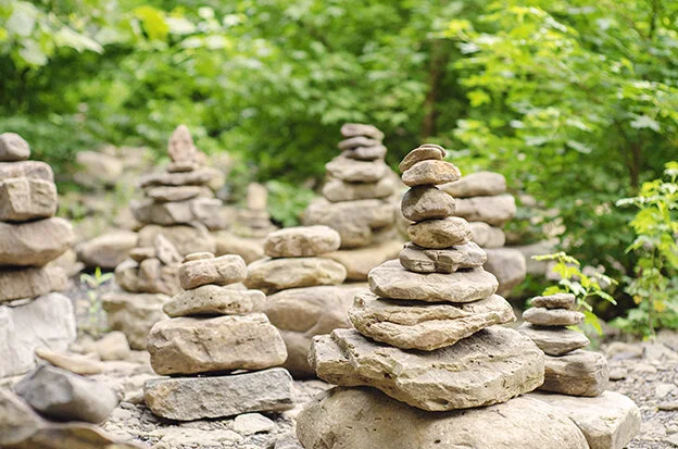 Stacked rocks with green trees beyond