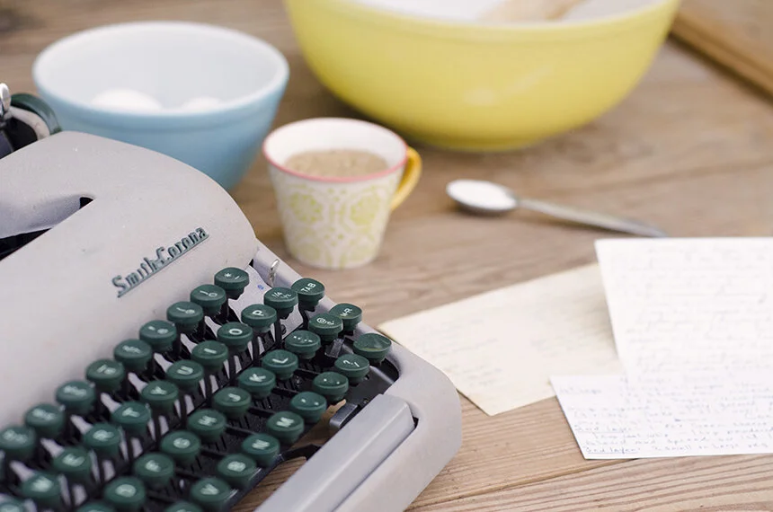 Smith Corona typewriter by Pyrex bowls, recipe cards, and measuring cups