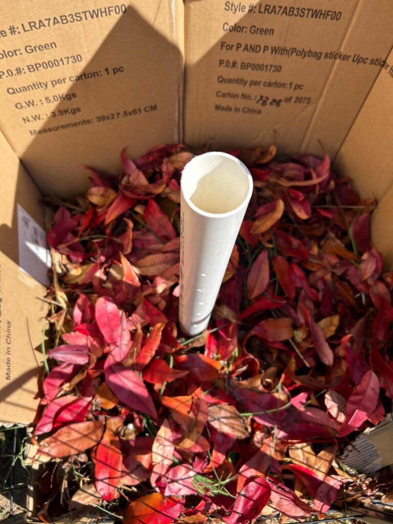 The same compost heap filled with beautiful red leaves.