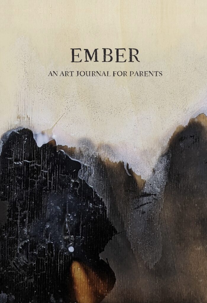 Ember: an art journal for parents. The cover is a burned piece of wood layered with transparent white paint.