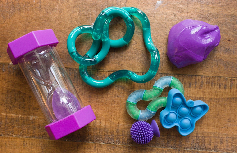 Collection of fidgets and a sand timer