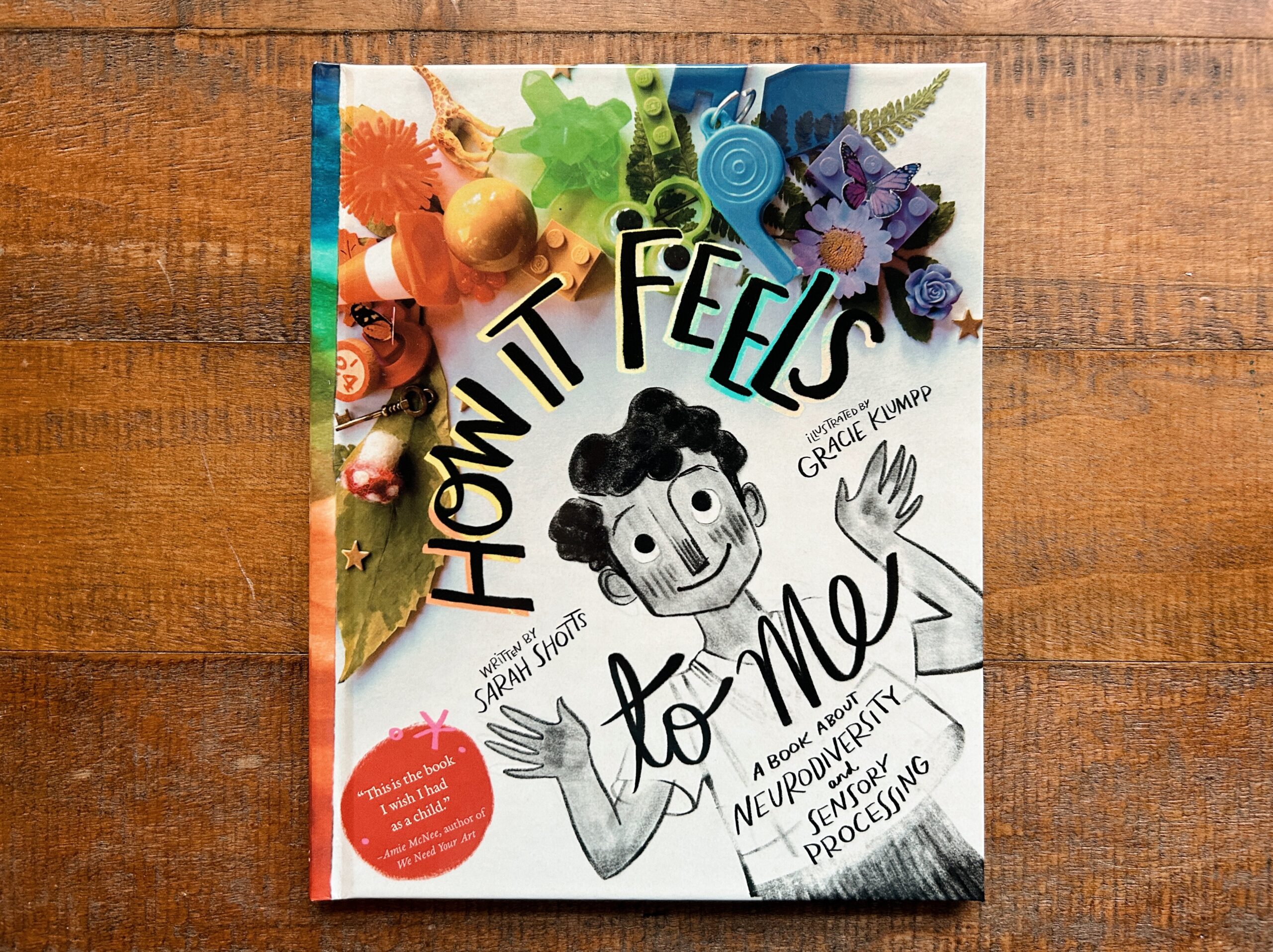 How it Feels to Me book cover by Sarah Shotts and Gracie Klumpp. Shows a child with hands raised and a rainbow collage of objects shown above.